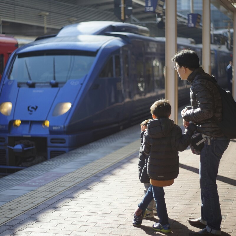 Dad with two children on train platform